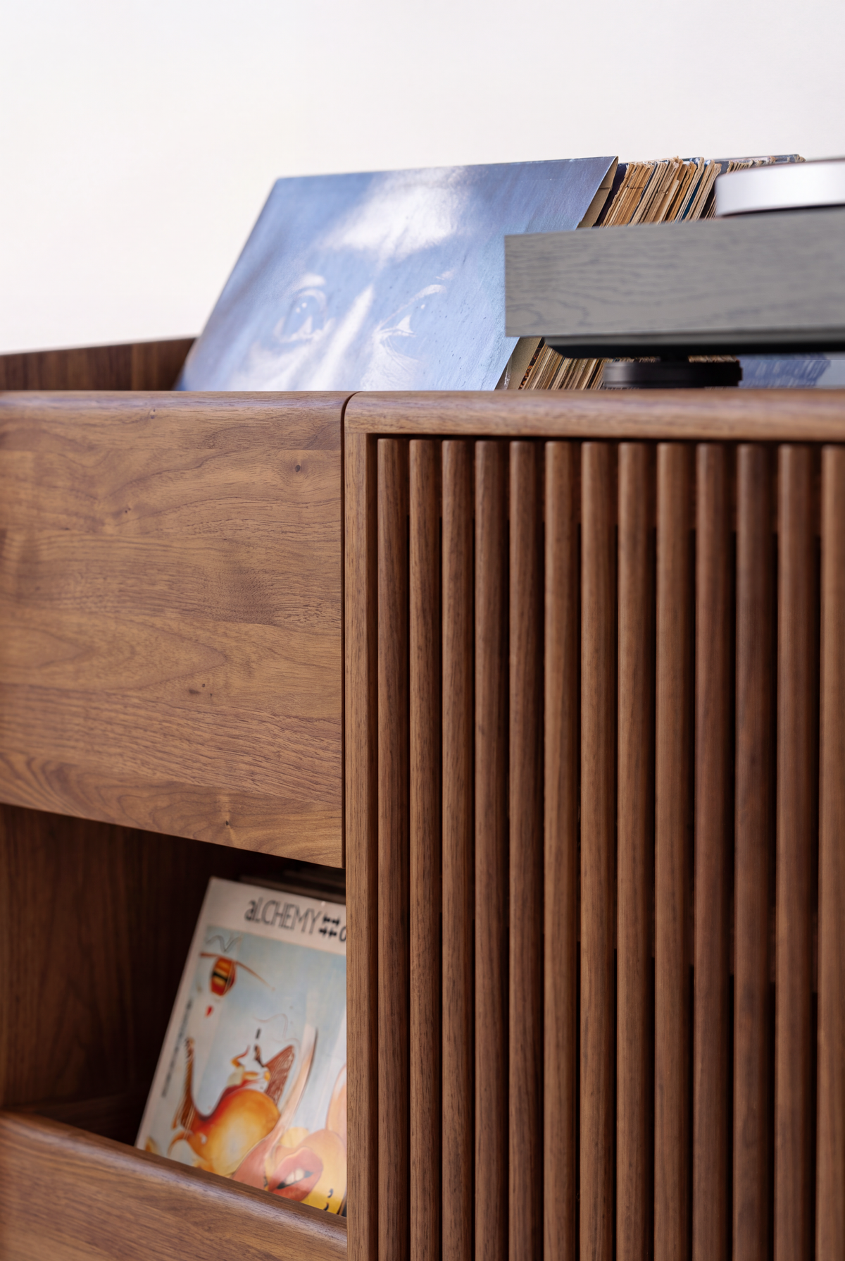 FUSE X in solid walnut, close-up of a drawer front, record niche and slatted door beneath records and a turntable