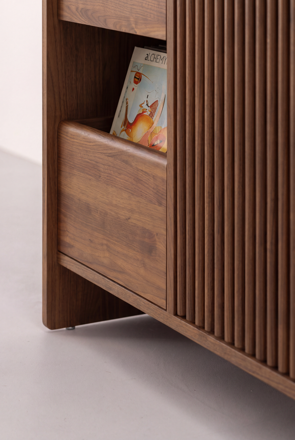 FUSE X in solid walnut, close-up near floor level of a drawer front, door slats, side panel and metal foot