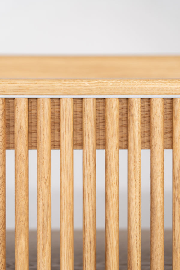 Front close-up of the FUSE XX in solid oak showing rounded vertical door slats beneath the rounded top edge