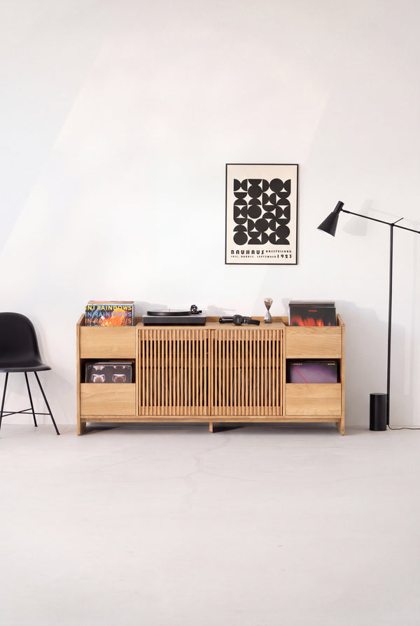 Front view of the FUSE XX hi-fi unit in solid oak, both slatted doors closed beneath a turntable and records