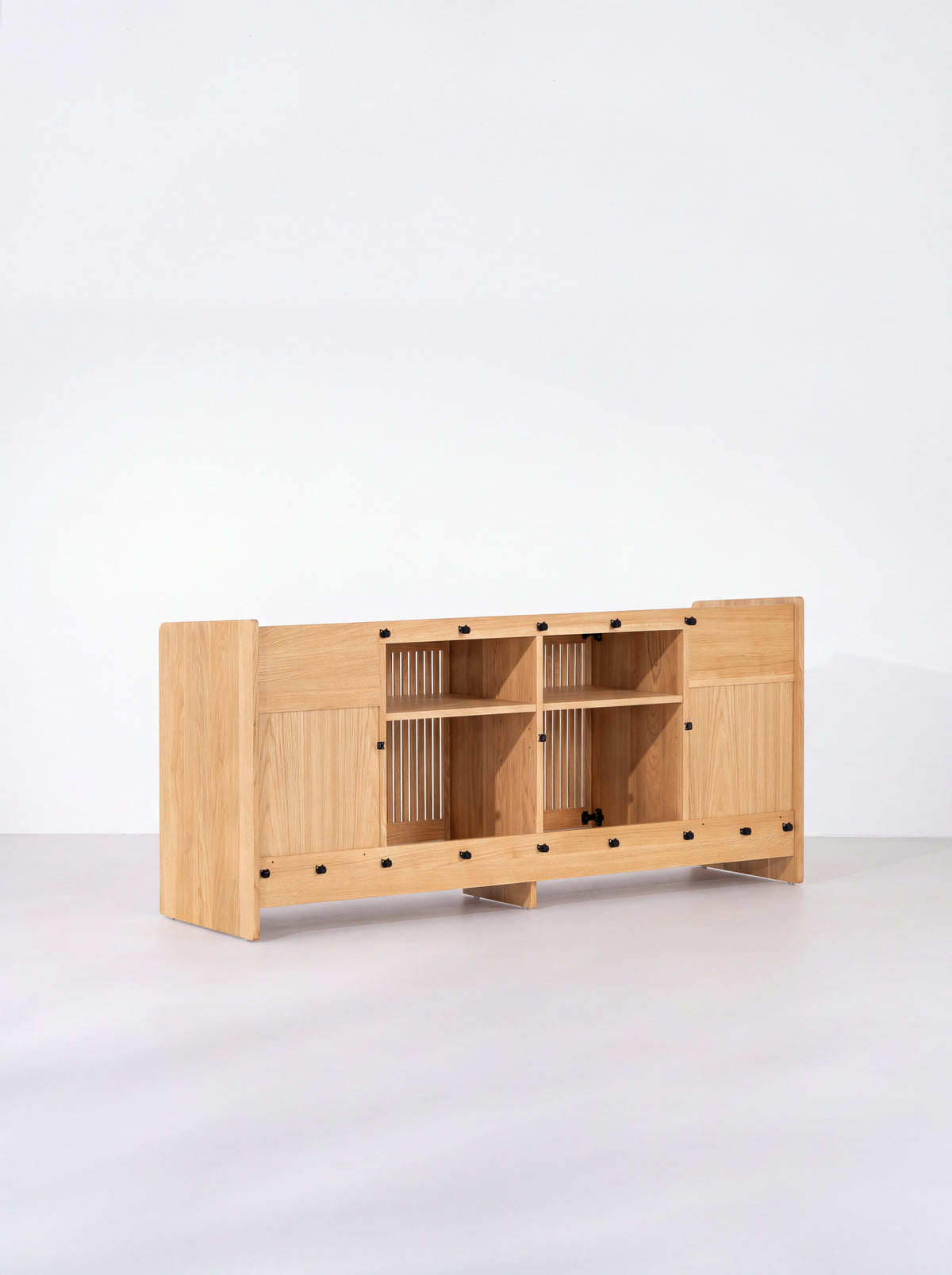 Rear view of the FUSE XX in solid oak showing two open center compartments, shelves and black fasteners