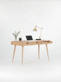HEIM 140 home office desk with drawers in oak wood, angled view with the right drawer open and a laptop on top