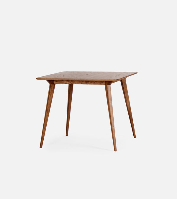 Wooden square table with slender, angled legs on a white background.