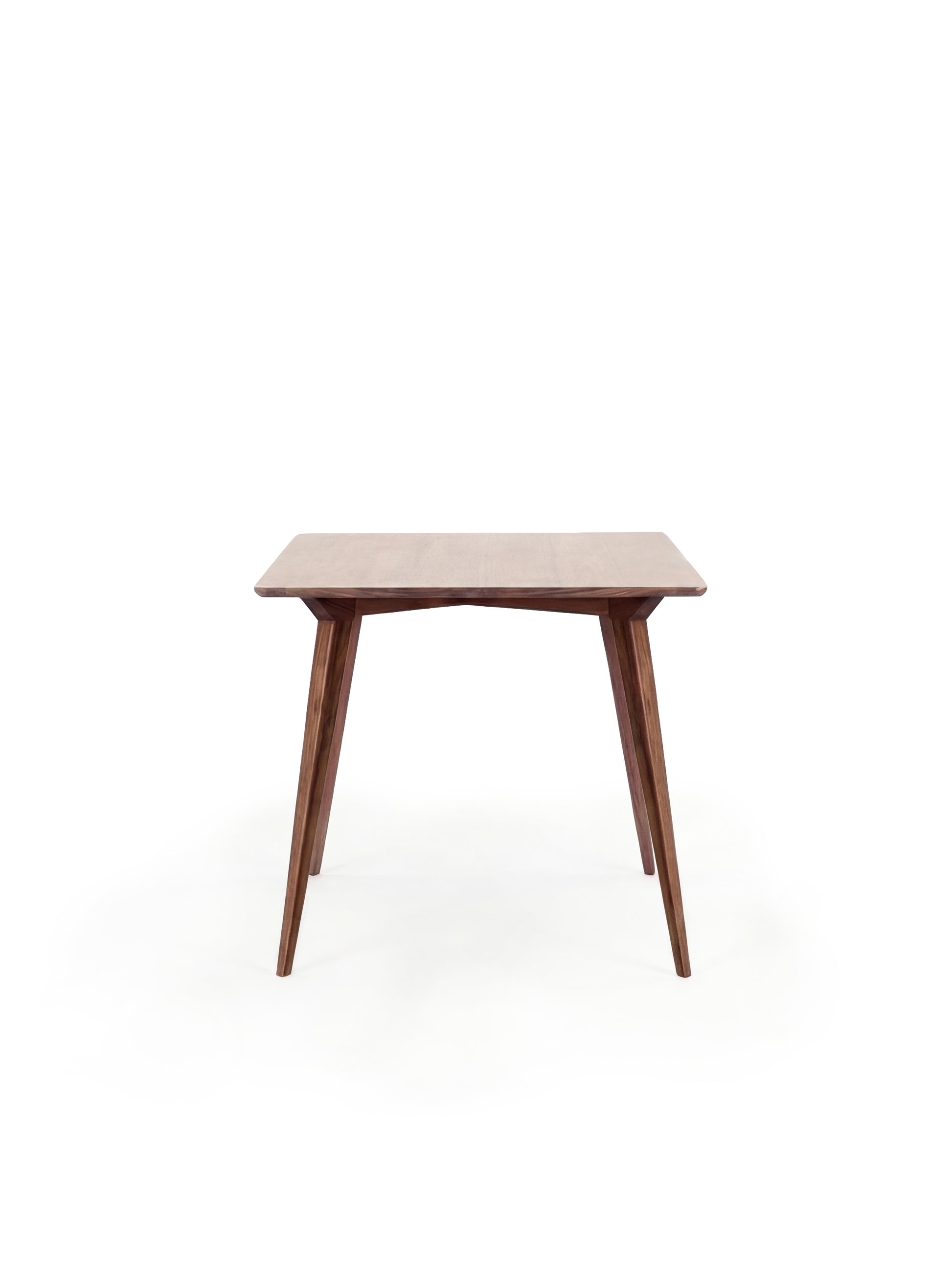  A wooden mid-century modern table with tapered legs against a white background.