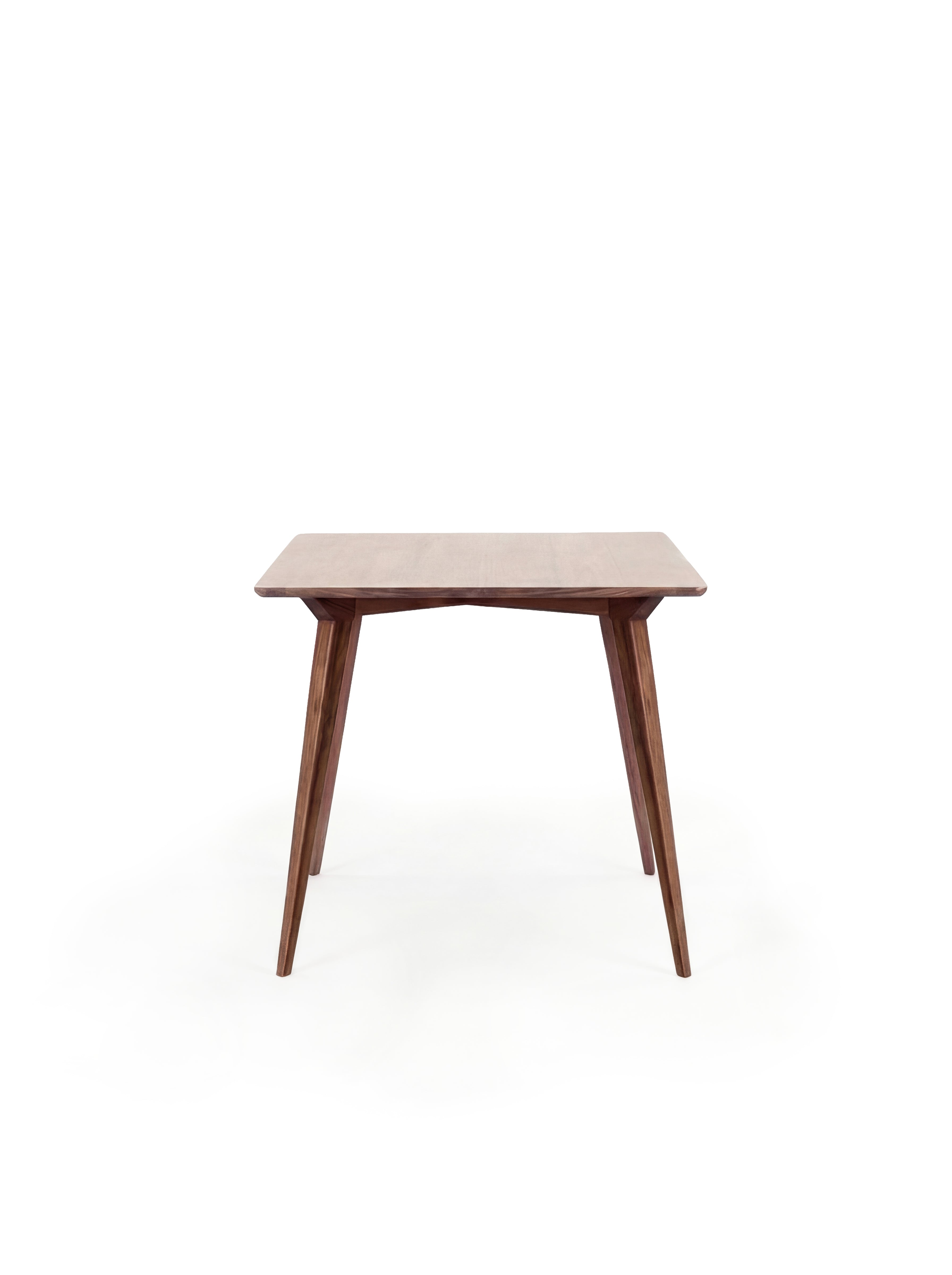  A wooden mid-century modern table with tapered legs against a white background.