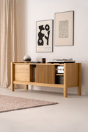 JAMM LOW 160 solid oak record player stand seen at an angle with turntable and amplifier, framed prints above