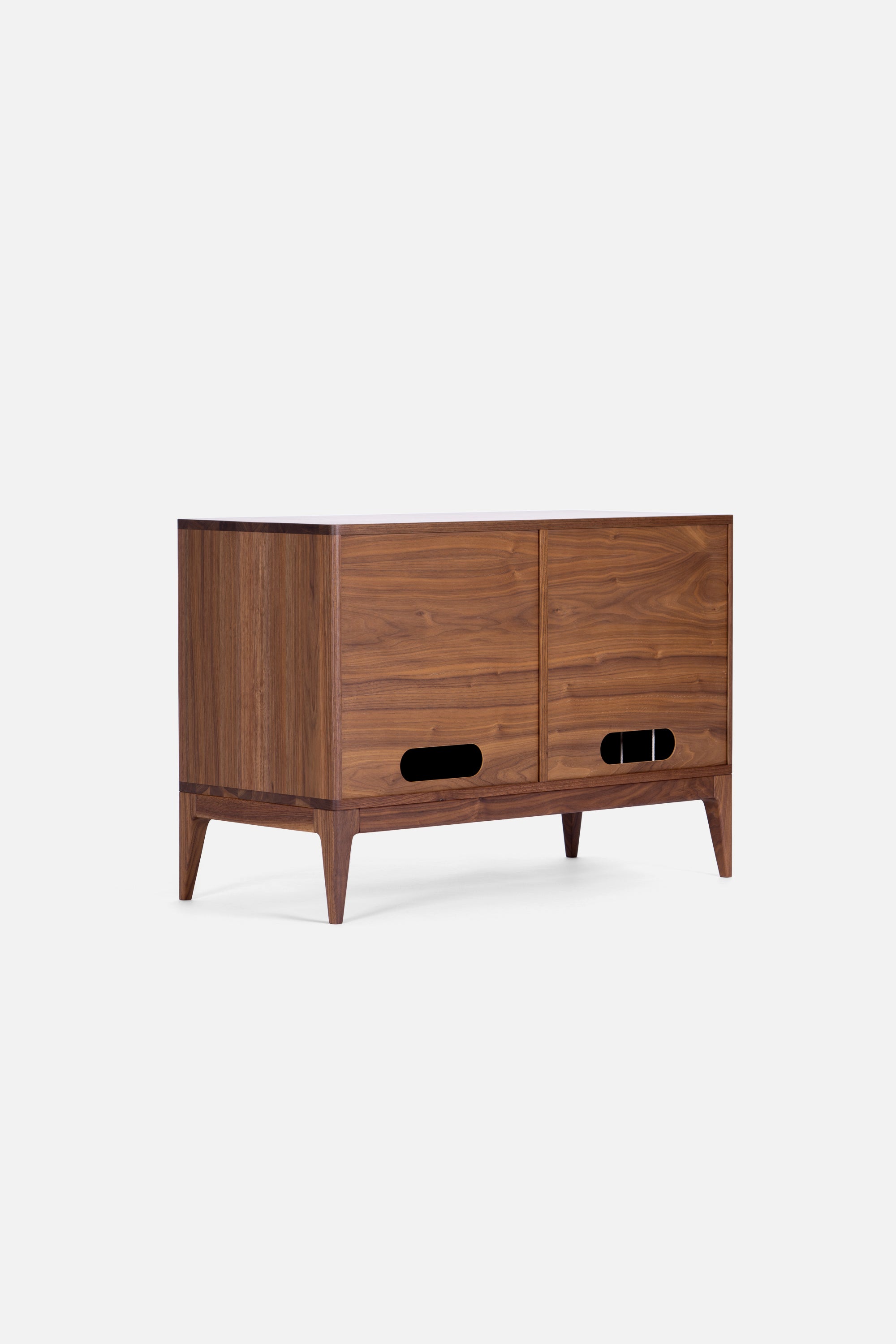 A modern wooden sideboard with two sliding doors and tapered legs against a plain white background.