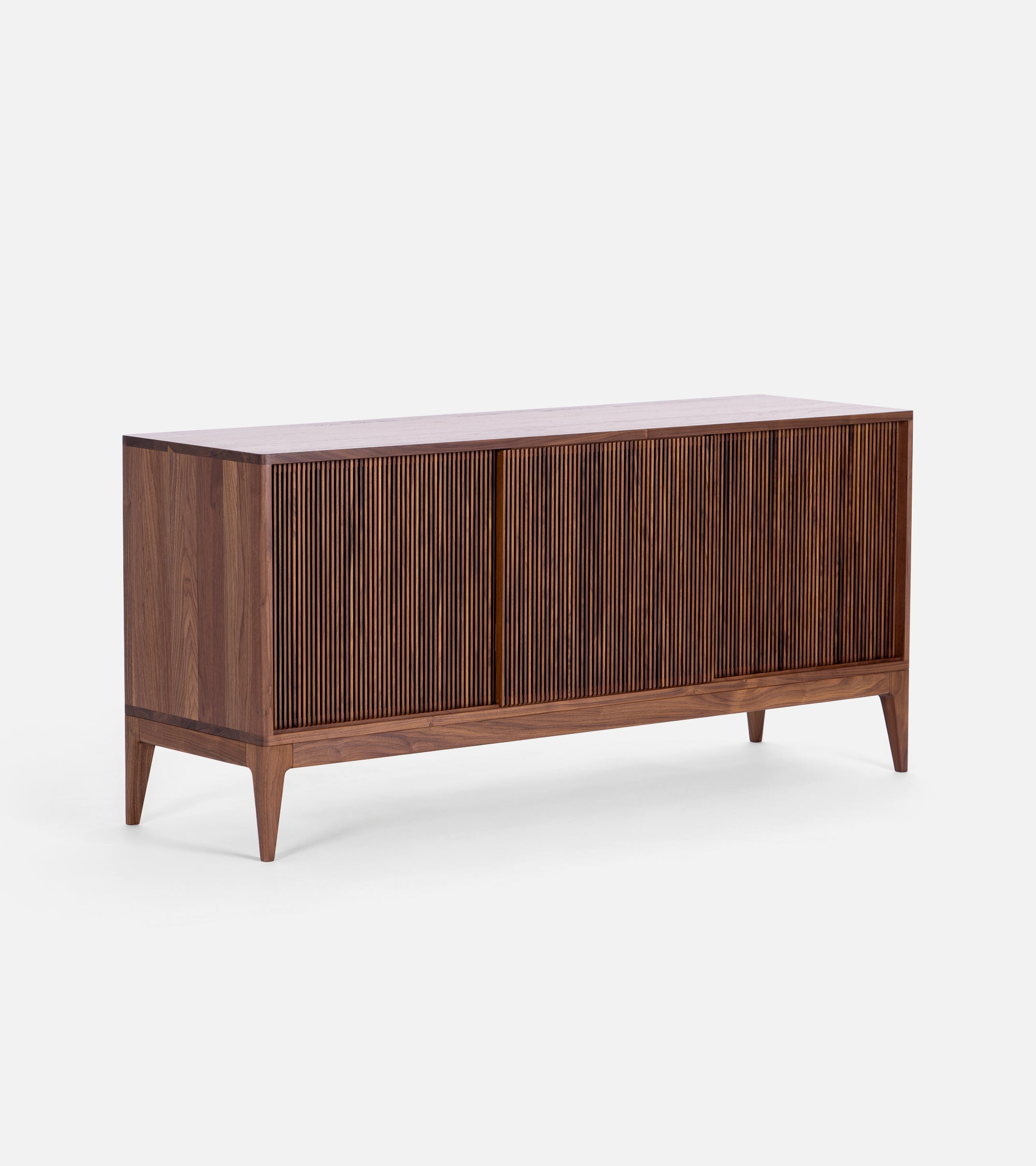 TONN 150 mid century record cabinet in solid American walnut, three-quarter studio view, three slatted sliding fronts closed