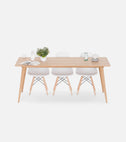 YRKE expandable dining table in solid oak, extended, seen from slightly above with the extension leaf in place, three white chairs