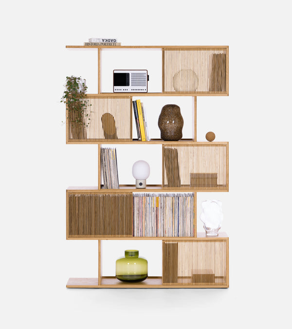 Modern wooden bookshelf with books, decorative items, and a potted plant.