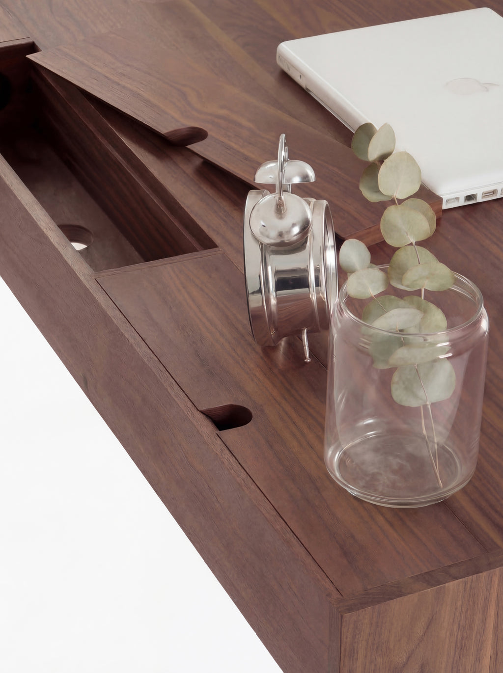 Overhead close-up of a raised cable flap and compartment with a round hole on the HEIM 140 desk in solid walnut