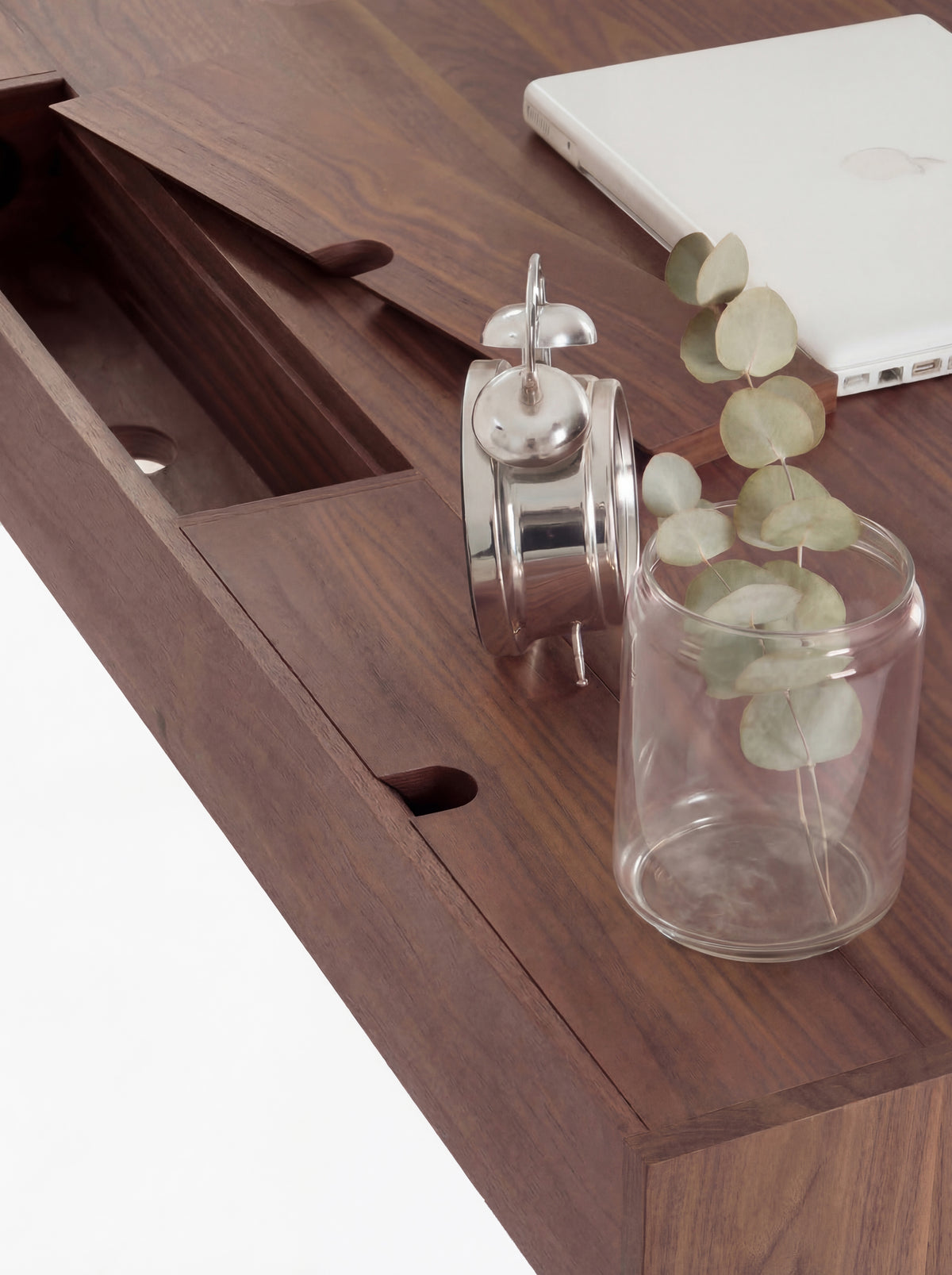 Overhead close-up of a raised cable flap and compartment with a round hole on the HEIM 140 desk in solid walnut