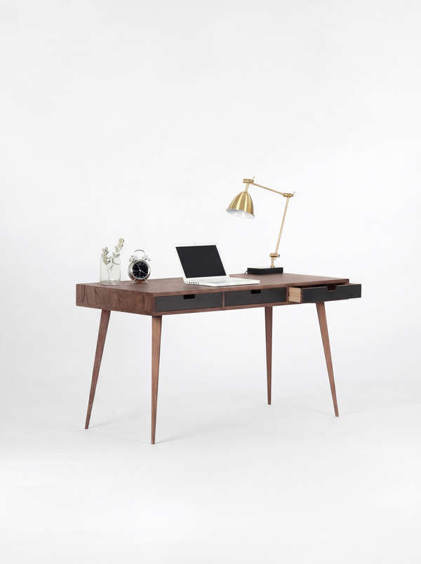 HEIM 140 desk in solid walnut with three black drawer fronts, the right drawer pulled out and a laptop on top