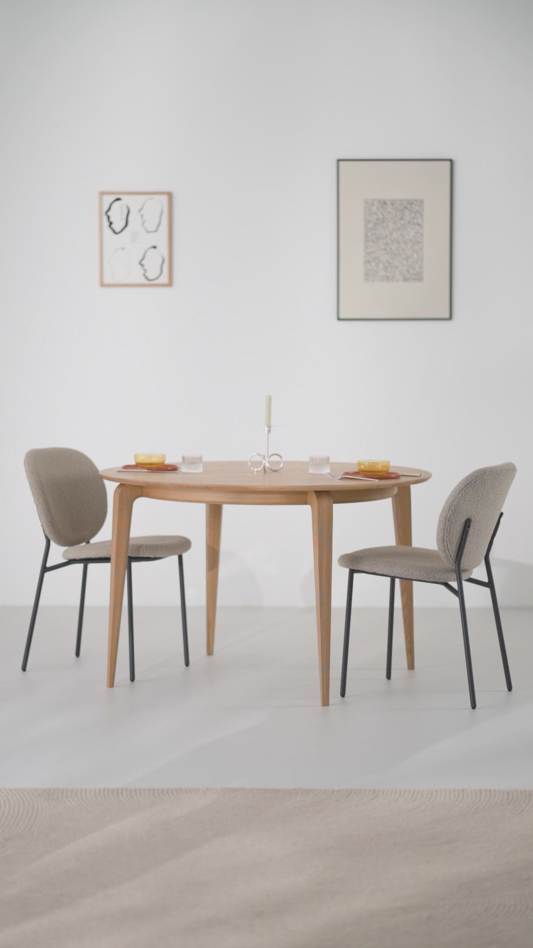 Product video of the YUKI round dining table in solid oak with angled legs and a bent frame