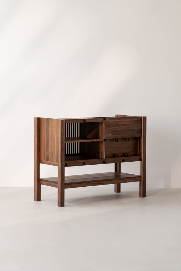 Wooden cabinet with open shelves and drawers, set against a plain white background.