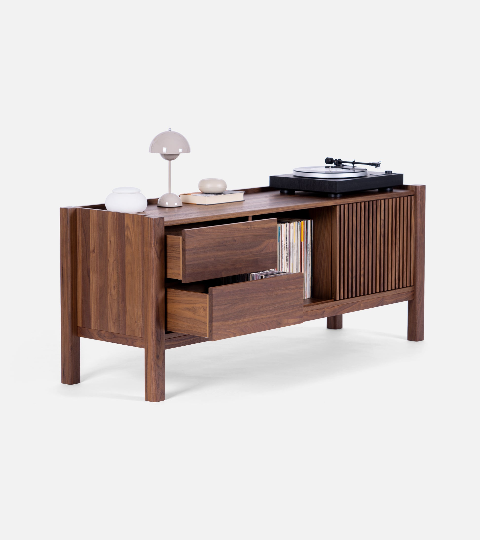 Modern wooden sideboard with open shelves, drawers, and a cabinet, holding a turntable, records, books, and decorative items.