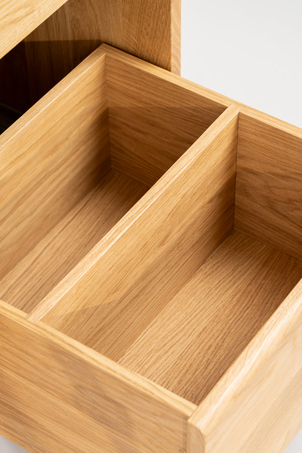 FUSE X in solid oak, close-up of an empty pulled-out drawer with a central divider and oak interior
