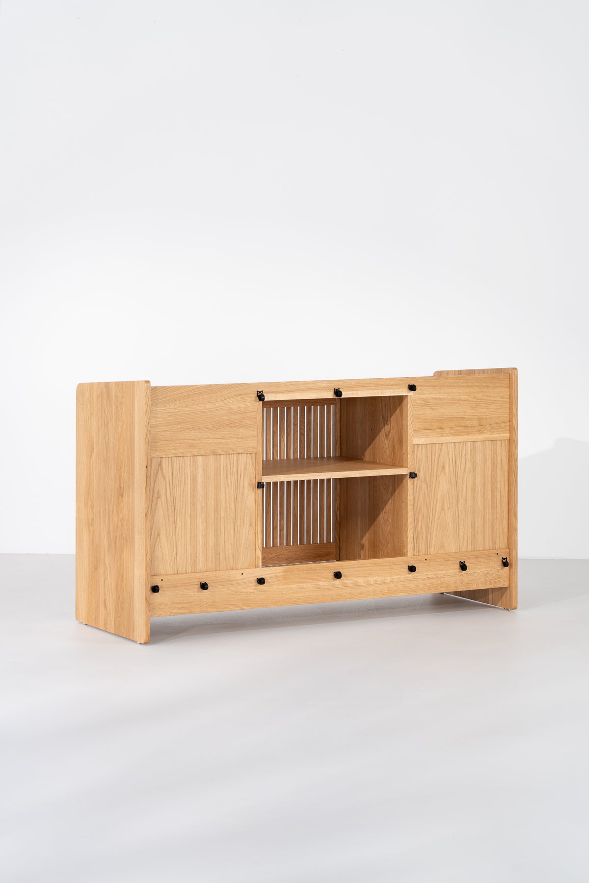 Rear view of the empty FUSE X in solid oak, showing an open center section, shelf and black cable fasteners