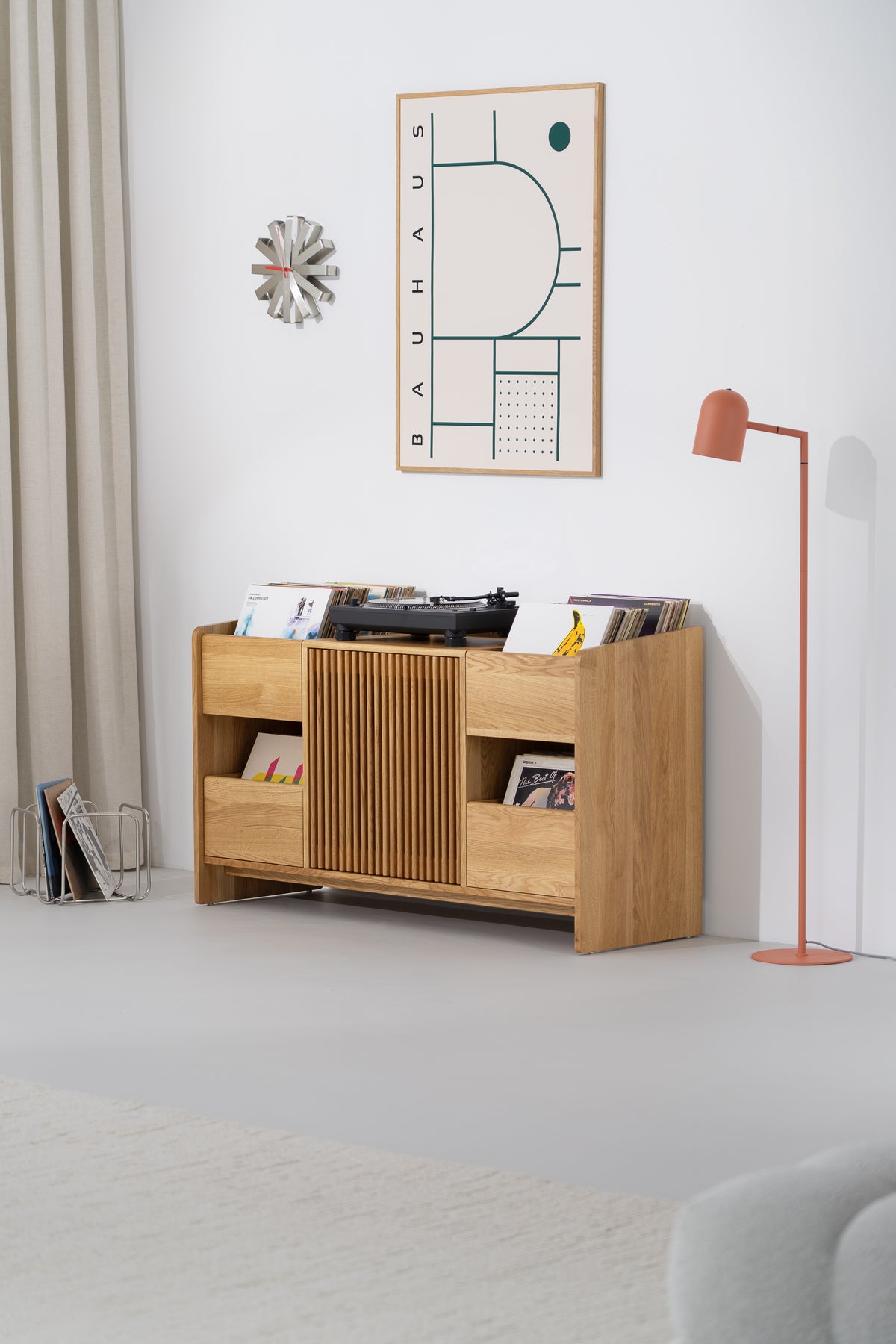 FUSE X in solid oak at a slight angle in a bright room, with turntable and records on top and records in side niches