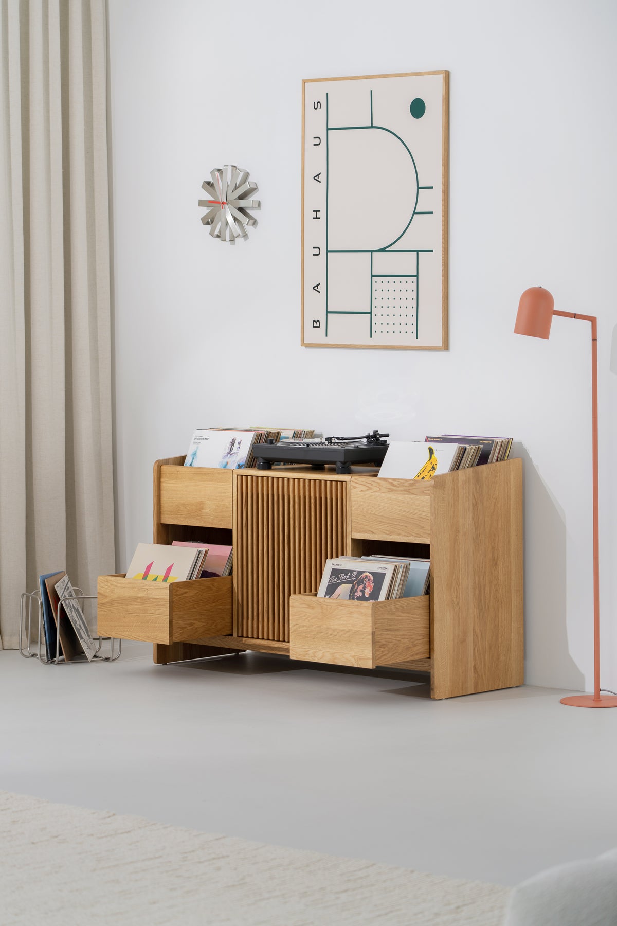 Three-quarter view of the FUSE X in solid oak with both side drawers pulled out and filled with records