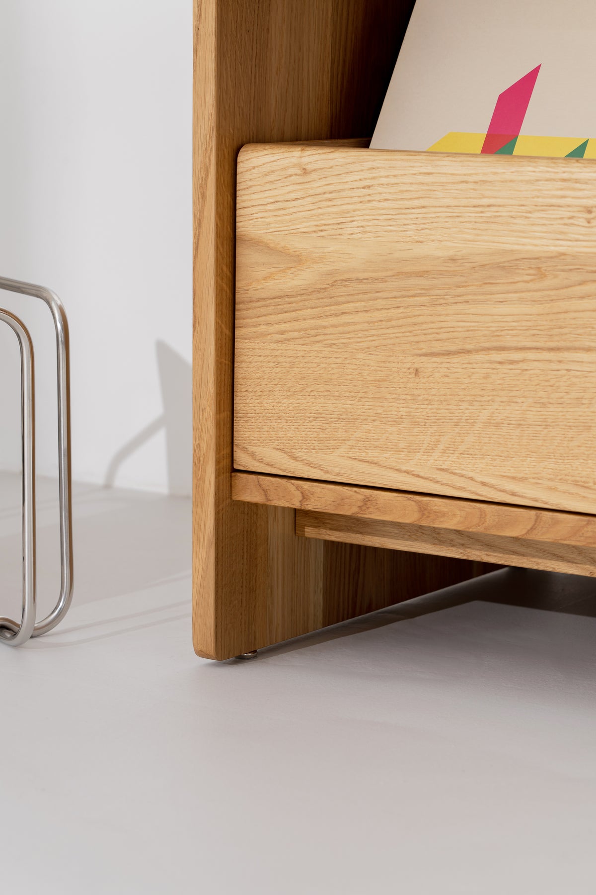 FUSE X in solid oak, side close-up of a closed drawer front below a record niche
