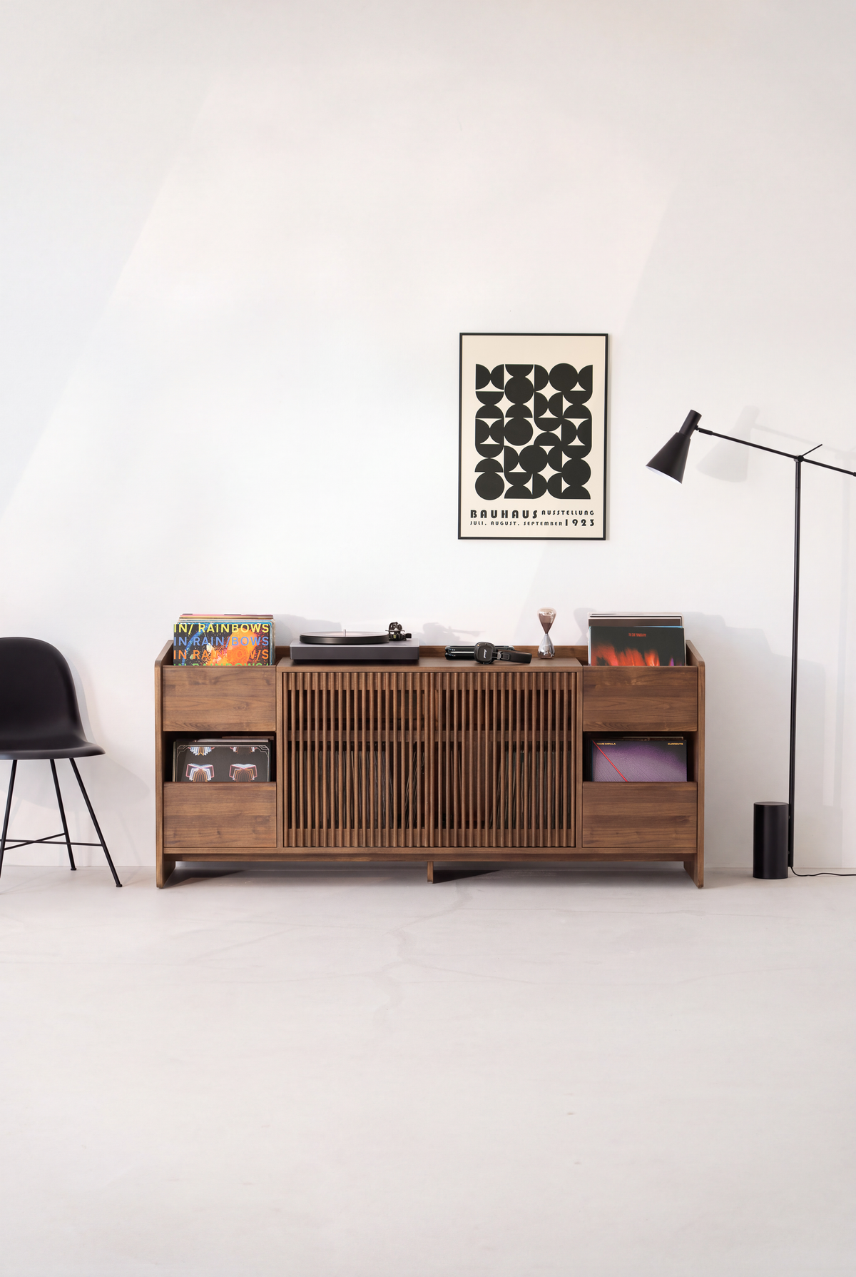 FUSE XX record storage console in solid walnut, front view with closed slatted doors and a turntable on top