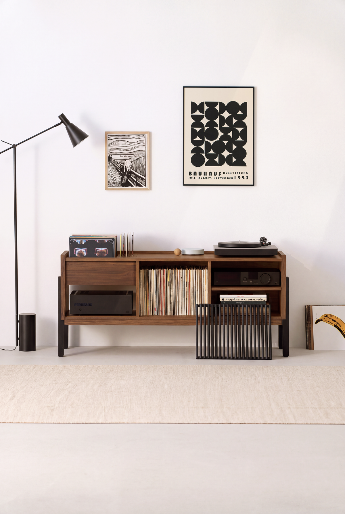 VIBE in solid walnut, front view with the black slatted front slid aside and a black slatted record rack on the floor