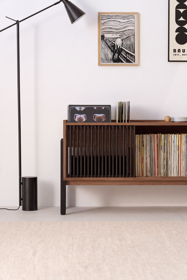VIBE in solid walnut, left section with a closed black slatted front and records beside it