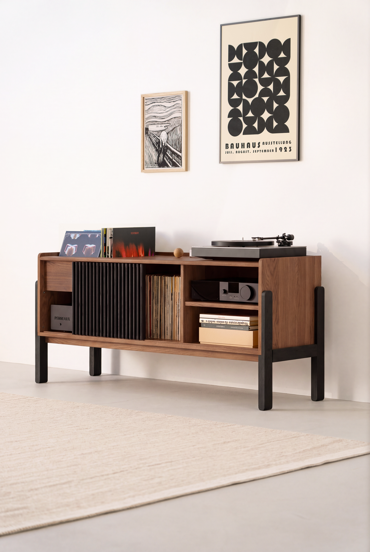 VIBE record storage unit in solid walnut at an angle, with a turntable, black slatted front and black legs