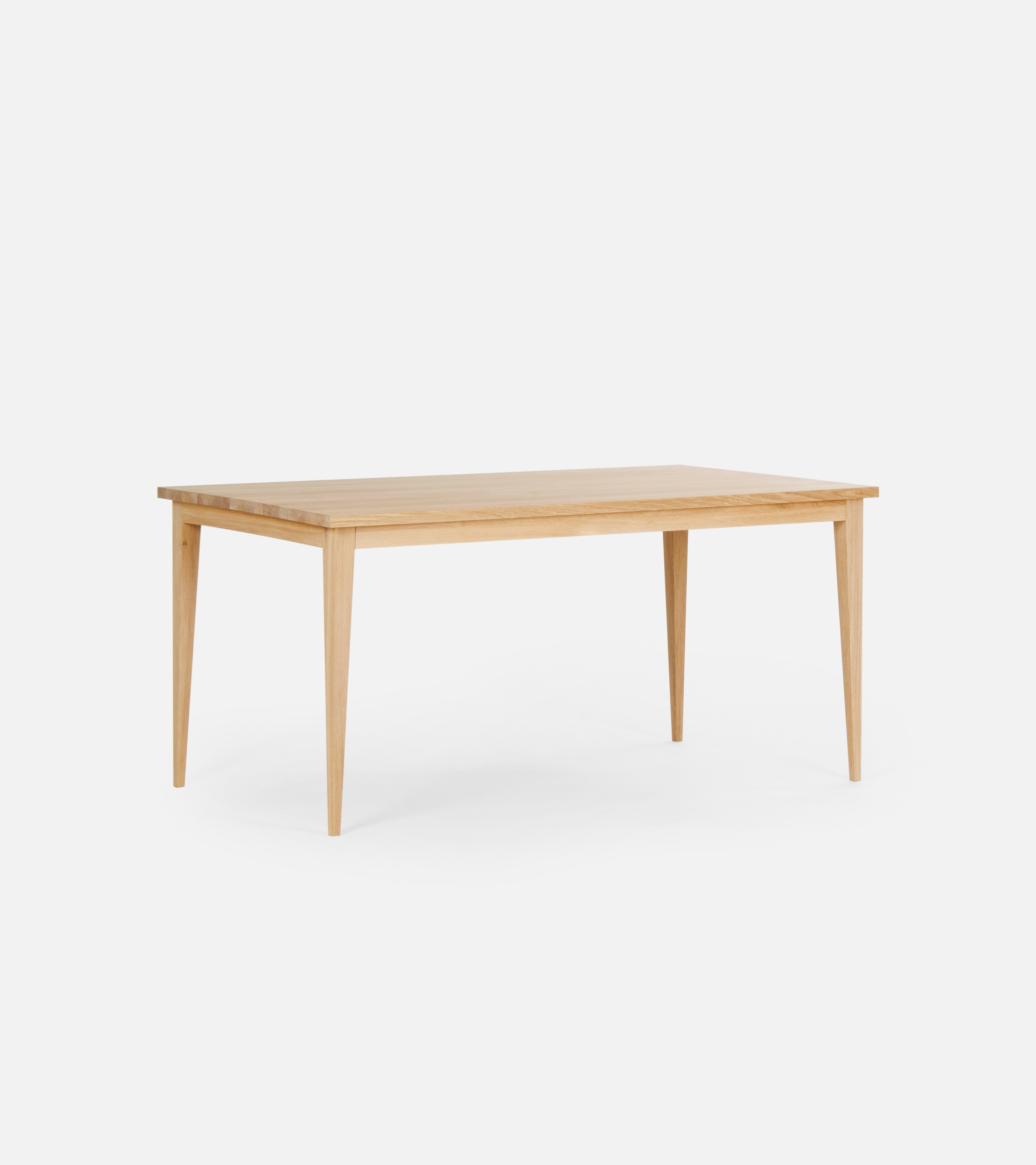 A wooden rectangular table with tapered legs against a white background.