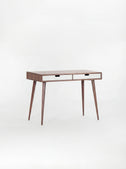 HEIM 105 desk in solid walnut, shown empty at an angle with two white drawer fronts on a white background