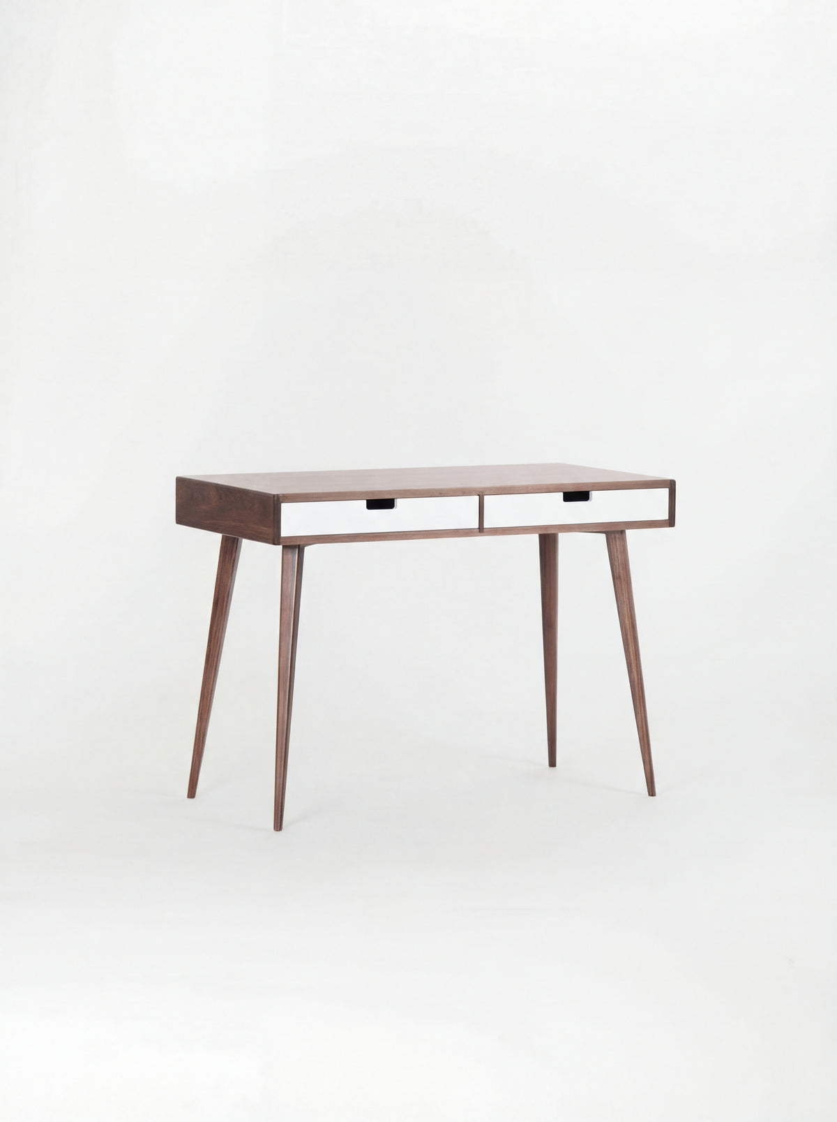 Angled HEIM 105 desk in walnut wood with two white drawer fronts, against a plain white background