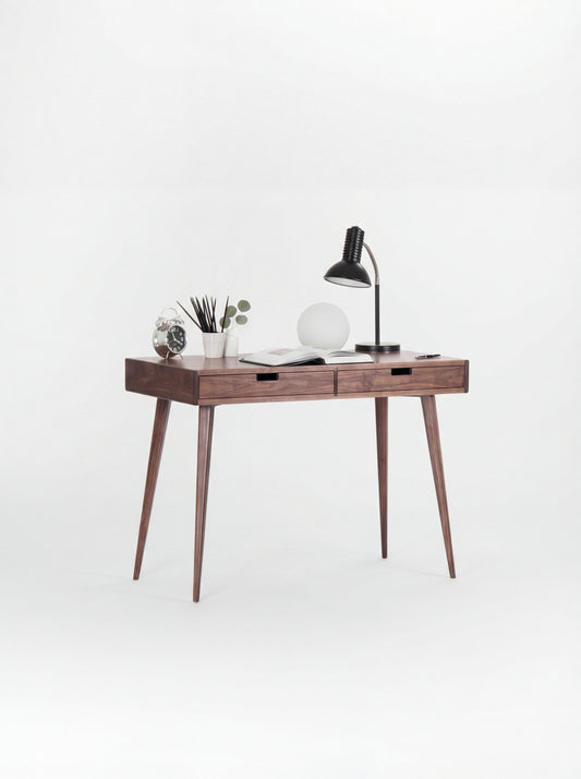 HEIM 105 small desk with drawers in walnut wood, angled view with two lamps and an open book