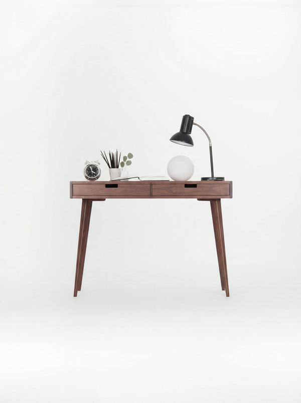 HEIM 105 desk in walnut wood, front view with wooden drawer fronts, lamps and an alarm clock