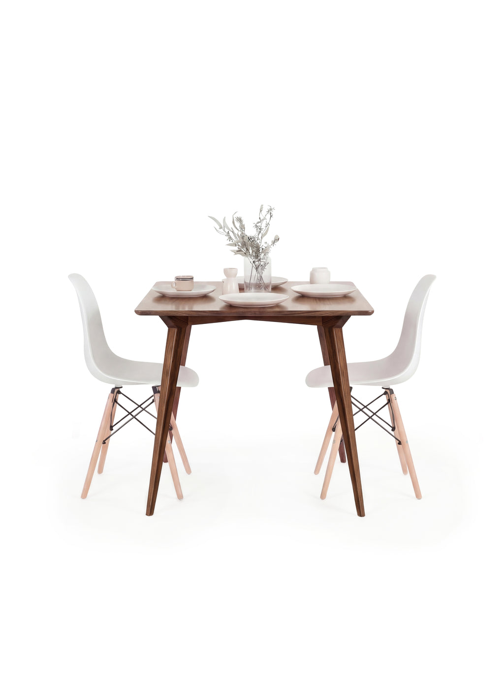  Wooden table with white chairs, small vase with flowers, and minimal decor on top.