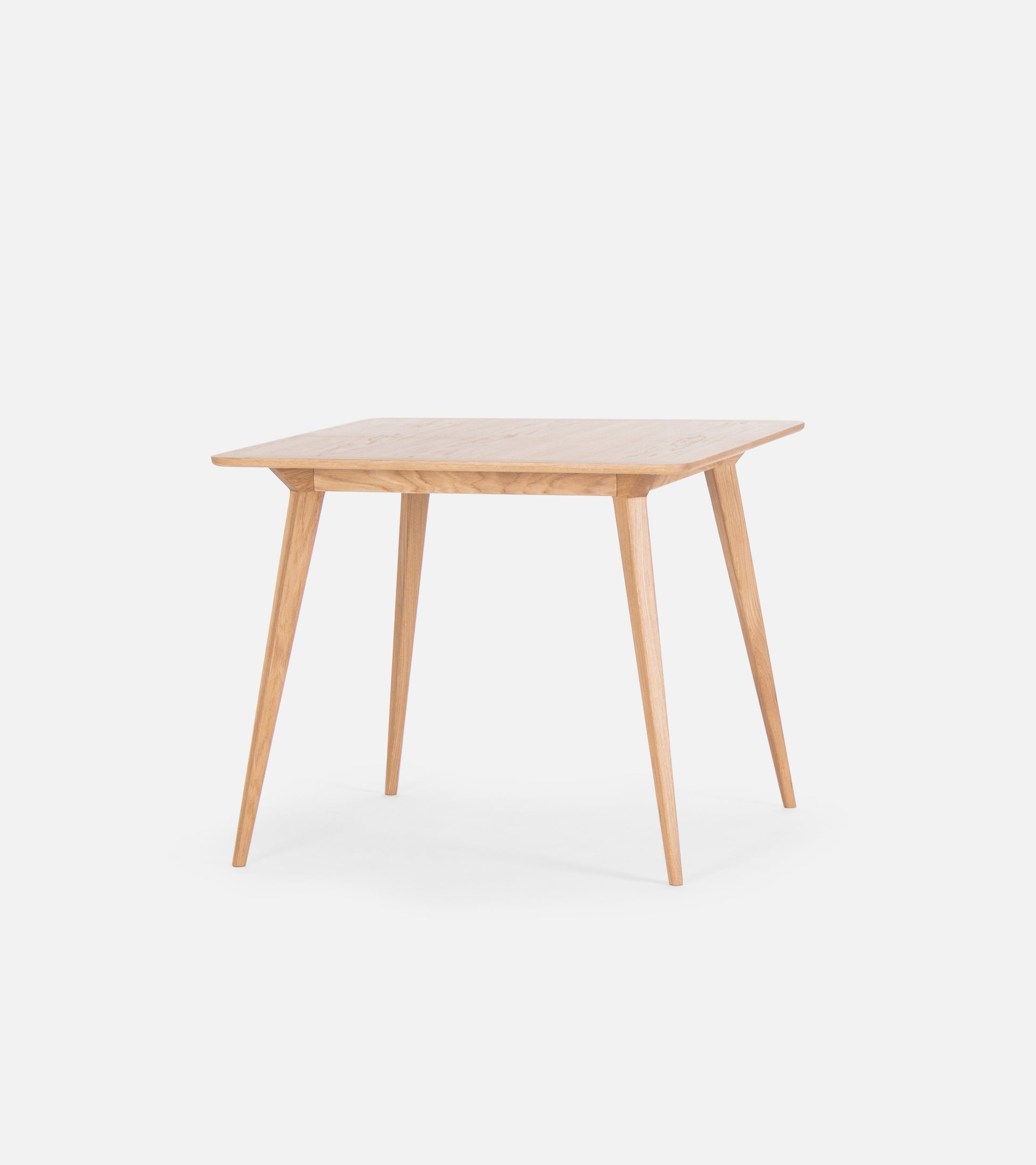 A small, light wood table with a simple, modern design and four tapered legs.