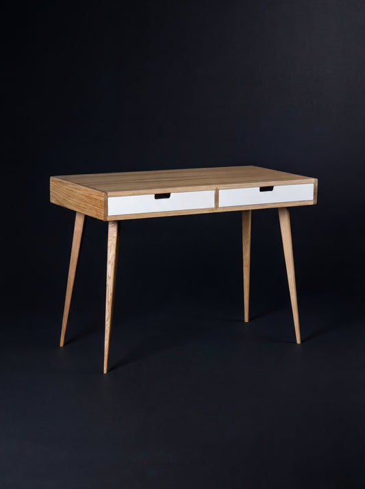 Empty HEIM 105 desk in oak wood, angled view with two white drawer fronts and oak legs on a dark background
