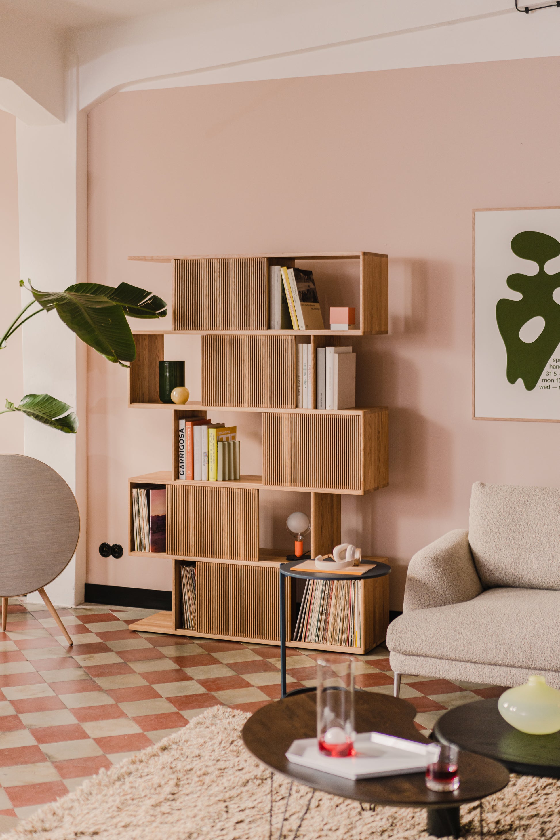 Solid oak vinyl and book storage unit in mid-century modern living room, styled with books, records, and decorative items.