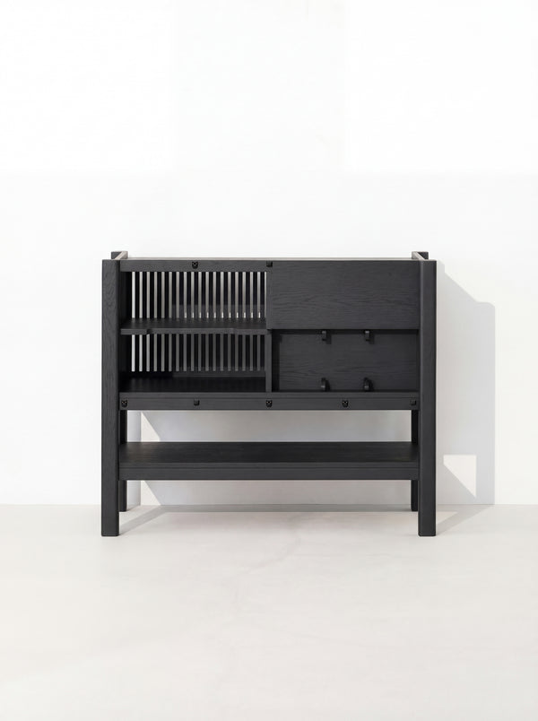 Black, modern cabinet with slatted left side and closed right side, set against a white background.