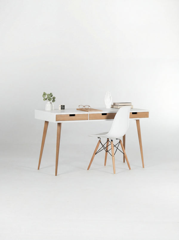 HEIM 140 white desk with drawers in oak wood, angled view with natural oak fronts and a white shell chair