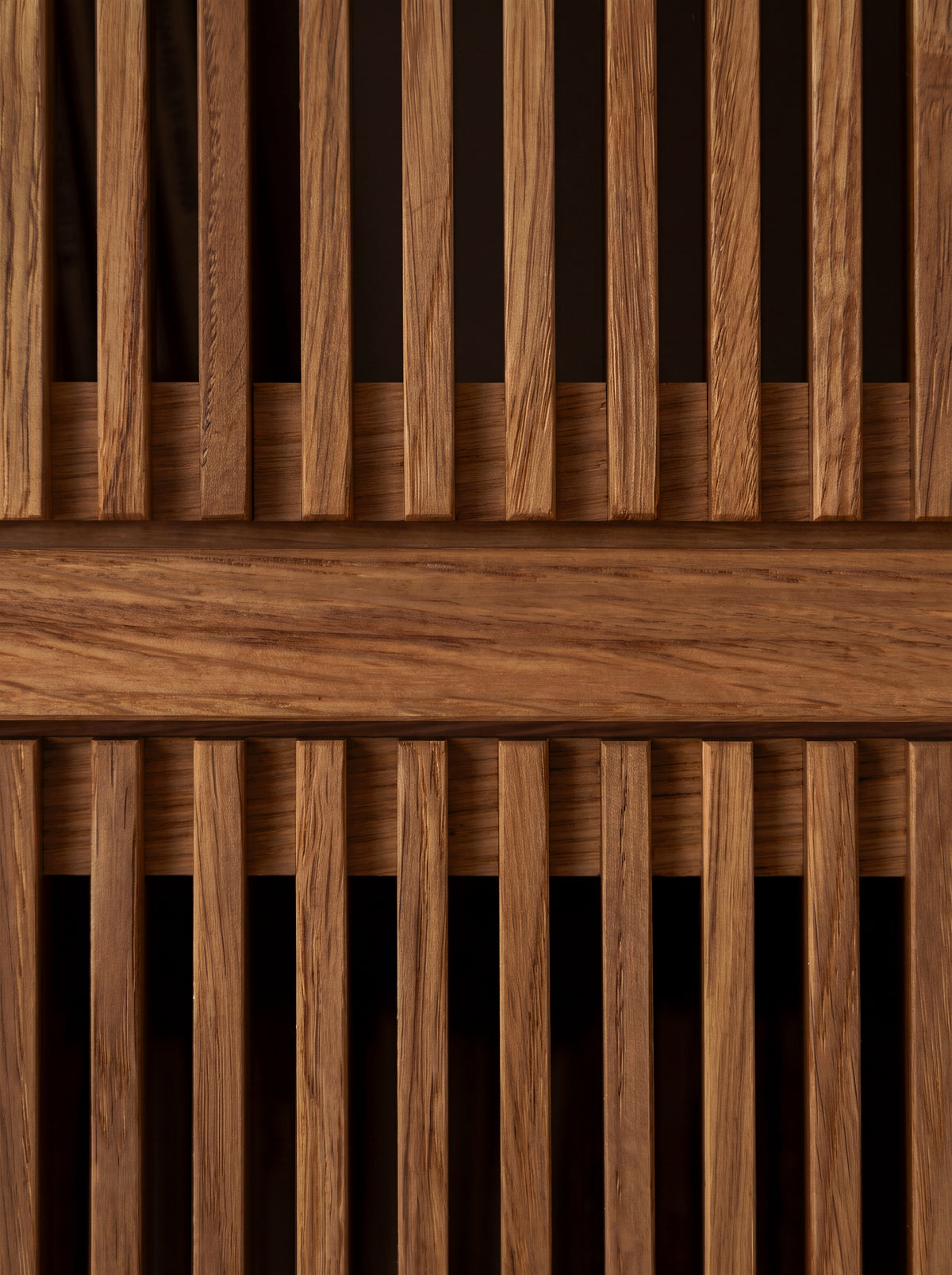 Macro of two fronts on MOLL in solid walnut, with vertical slats above and below a shelf edge