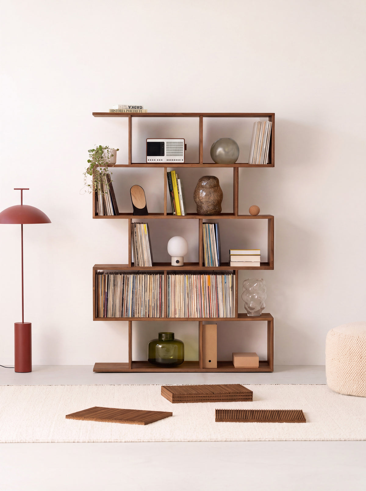 MOLL in solid walnut with all fronts removed, books and records on open shelves and three slatted fronts on the rug