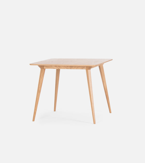 Simple wooden square table with four angled legs against a white background.