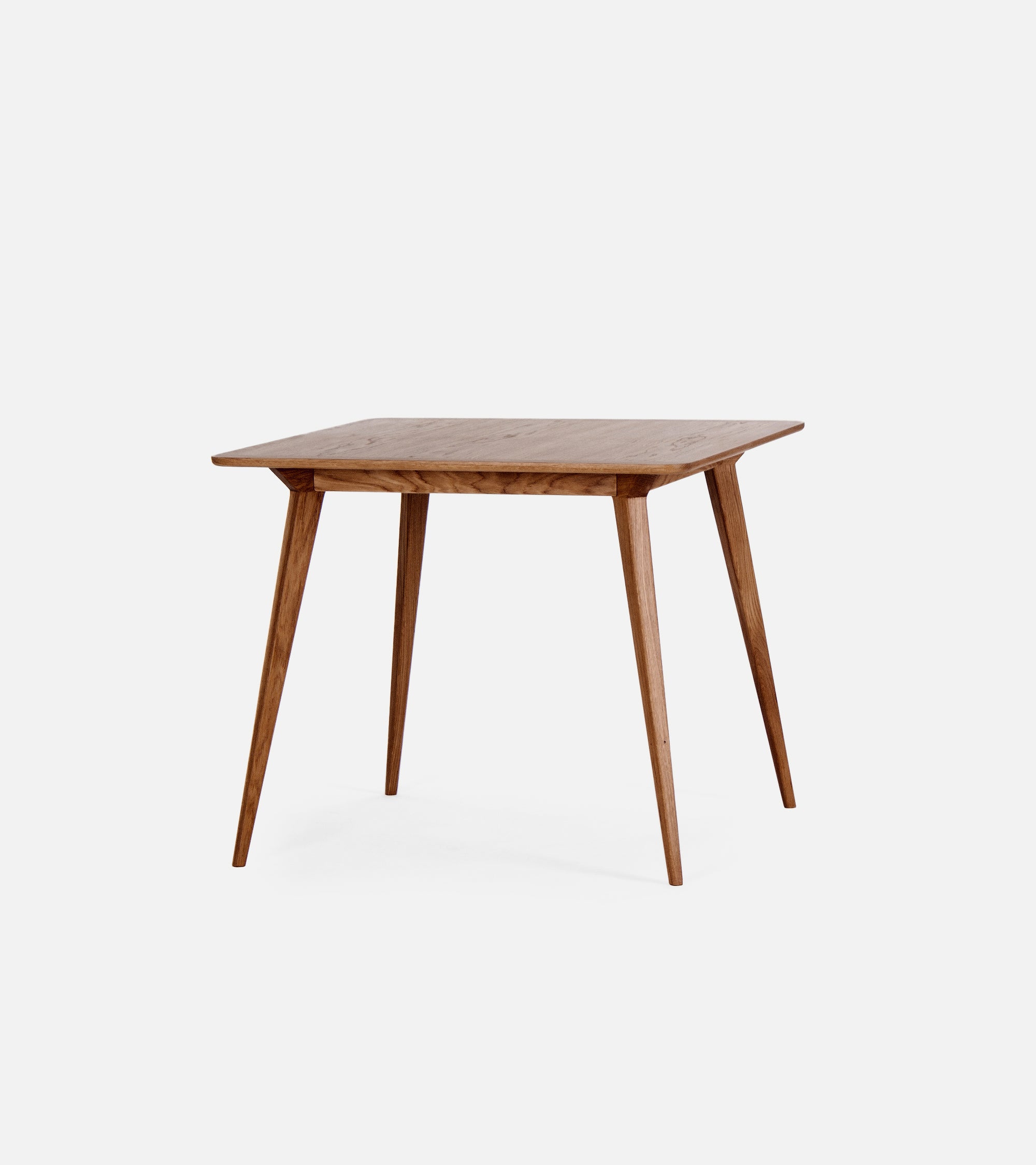 Wooden square table with tapered legs on a white background.