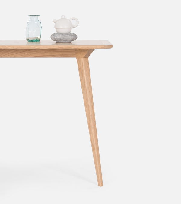 Wooden table with a vase and teapot.