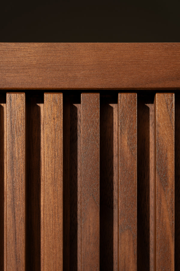 Close-up of vertical wooden slats with a horizontal top, featuring natural wood grain texture.