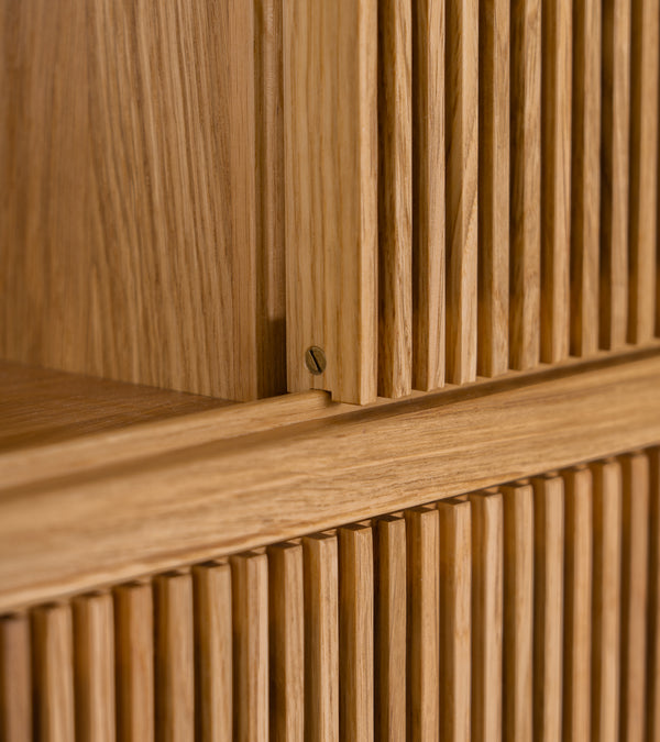Close-up of wooden slatted texture with a small brass screw.