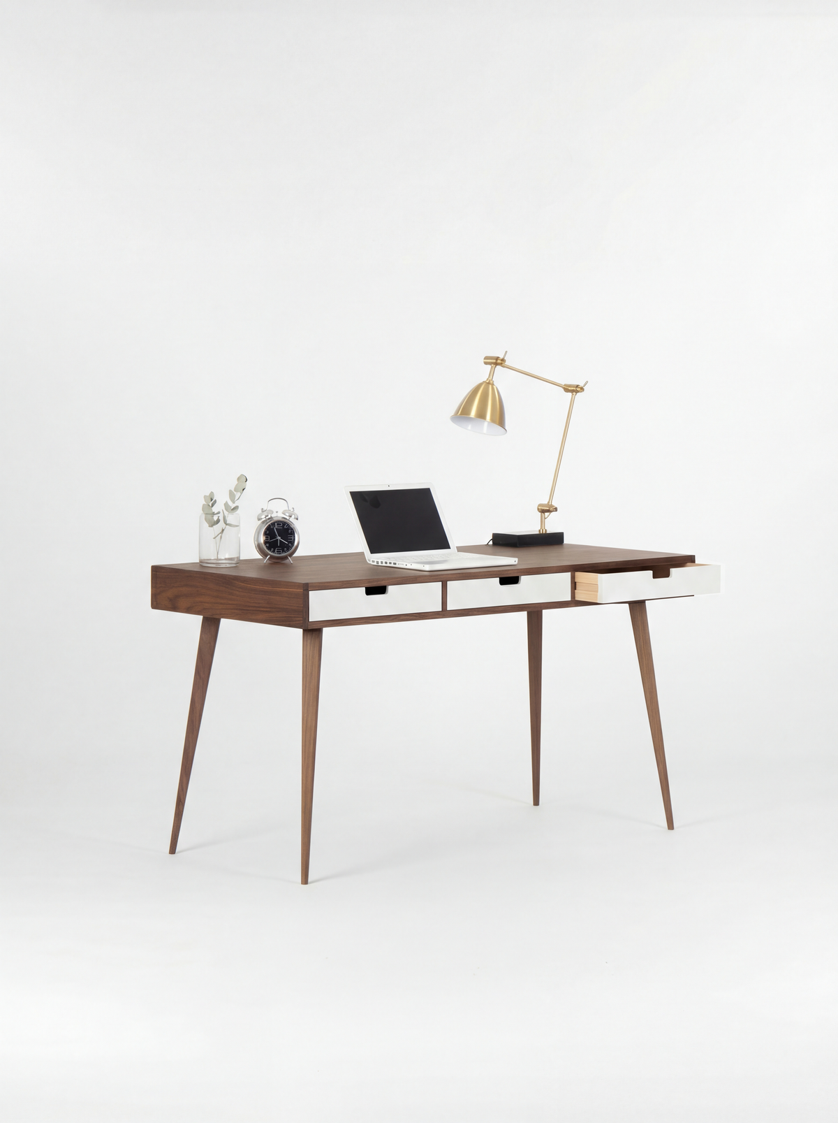 HEIM 140 desk in walnut wood, angled view with three white drawer fronts, an open right drawer and a brass lamp