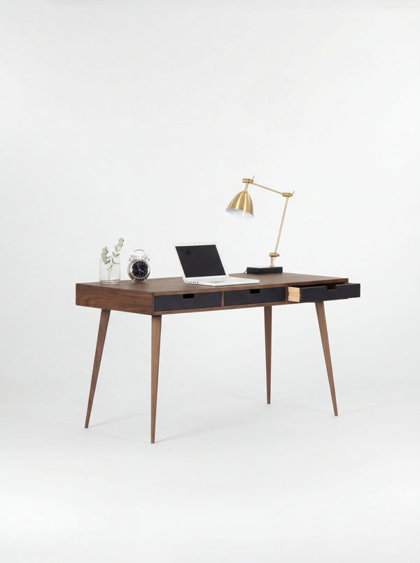 HEIM 140 desk in walnut wood with three black drawer fronts, the right drawer open and a clock on top